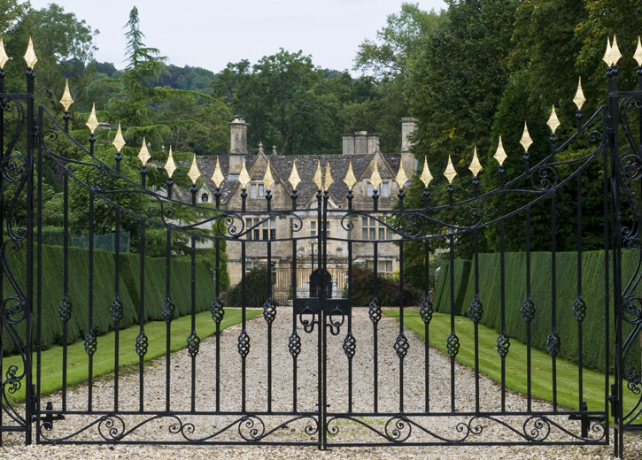 A large mansion with an iron gate in front