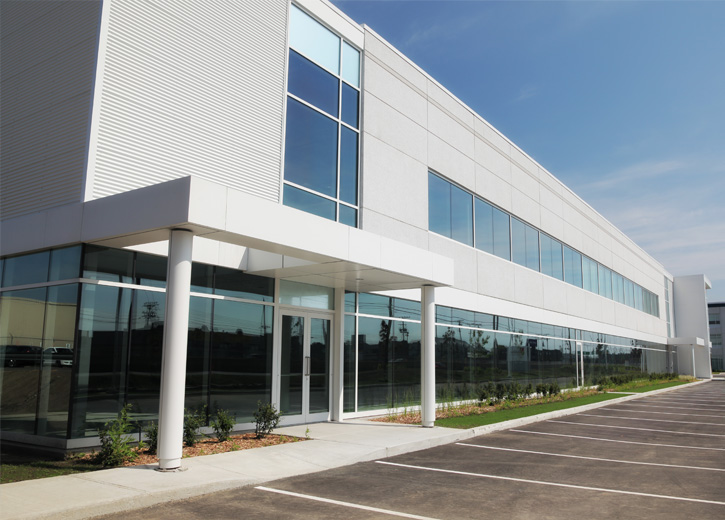 White office building with no cars in the parking lot
